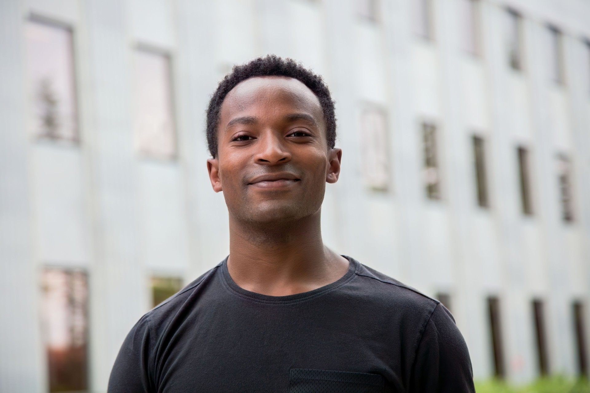 Young man smiling, big smile african Student on college campus university city life
